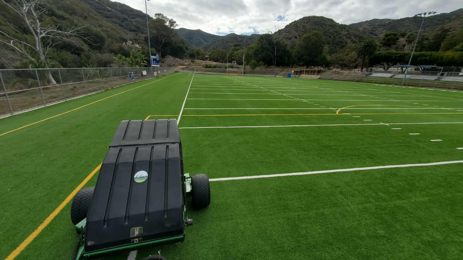 Field groomer on athletic turf